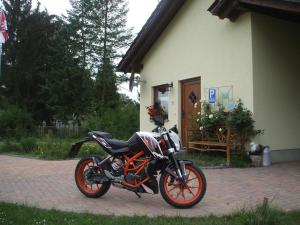 a motorcycle parked in front of a building at Ferienhaus in Kienitz mit Grill, Terrasse und Garten in Letschin