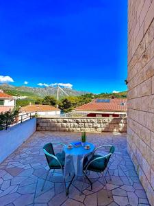 a patio with a table and chairs on a stone patio at Apartment Asi in Dubrovnik