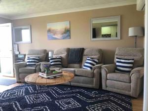 a living room with two couches and a coffee table at The Phoenix by the Sea- 2 bedroom flat in hunny in Hunstanton