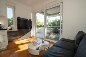 a living room with a couch and a large window at Adriatic Escape Novalja-Zrce! in Novalja