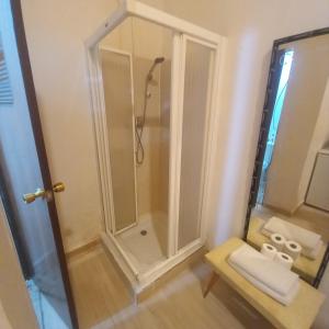 a shower with a glass door in a bathroom at Aurora Room with Private Bathroom in Alicante