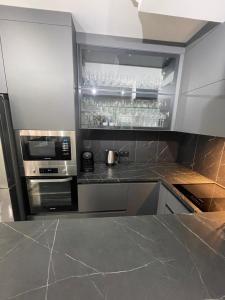 a kitchen with stainless steel appliances and a counter top at Appartement 3 pieces 2 minutes à pied RER vers Paris in Gagny