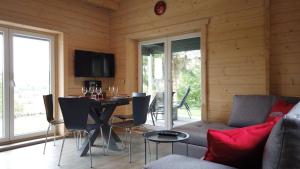 a dining room with a table and chairs at Wellnorama 2 - WellnessFerienhaus mit Pool, Sauna und eigenem Whirlpool mitten in Deutschland in Wasungen