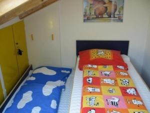 a bedroom with two beds with colorful sheets at Ferienwohnung in Garmisch-Partenkirchen - b48490 in Garmisch-Partenkirchen