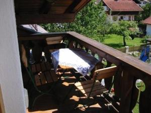 a porch with a table and chairs on a deck at Ferienwohnung in Garmisch-Partenkirchen - b48490 in Garmisch-Partenkirchen