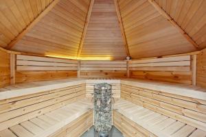a wooden sauna with a pillar in the middle at Ferienhaus mit naturnahen Badeteich in Nordhausen