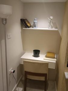 a room with a desk with a chair and a book at ستوديو فندقى فاخر بالزمالك in Cairo