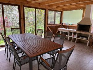 a dining room with a table and chairs in a cabin at Къща за гости - Еделвайс, гр. Габрово in Gabrovo