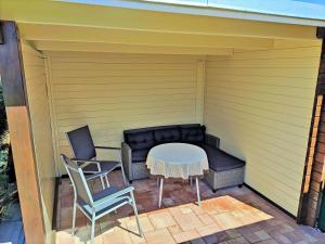 a small patio with a table and two chairs at Freistehendes Ferienhaus in Rott mit eigenem Garten, schöner Weitblick, Klimaanlage, Sauna und Kamin in Extertal
