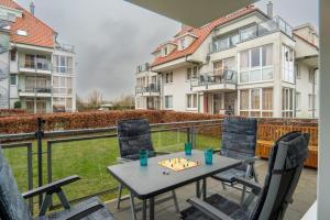 a table and chairs on a balcony with a view at Strandpark-Grossenbrode-Haus-Moewennest-Wohnung-2 in Großenbrode