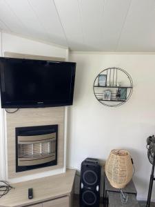 een woonkamer met een tv boven een open haard bij Wetter_wille in Earnewâld