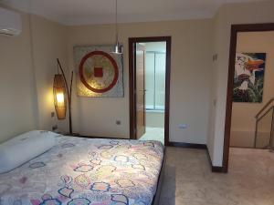 a bedroom with a bed and a mirror on the wall at Frataga Home in Playa Honda