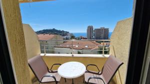 a balcony with a table and chairs and a view at Vila Lena in Petrovac na Moru