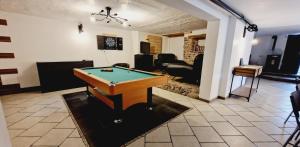 a living room with a pool table in it at Revauche et spa in Fresse-sur-Moselle