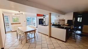 a kitchen and dining room with a table and chairs at Revauche et spa in Fresse-sur-Moselle