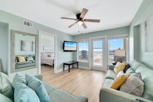 a living room with a couch and a ceiling fan at Boardwalk 187 in Gulf Shores