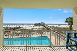 a balcony with a view of the beach and a pool at Boardwalk 187 in Gulf Shores