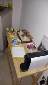 a wooden table with bowls of food on it at Appartamento Casa Margi in Ameglia