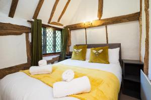 a bedroom with a bed with towels on it at Gildridge in Chiddingly