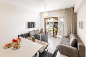 a living room with a table and a couch at Stephanos Hotel Apartments in Polis Chrysochous