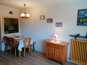 a dining room with a table and a radiator at Appartement Le Grand-Bornand, 1 pièce, 4 personnes - FR-1-241-65 in Le Grand-Bornand