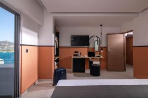 a hotel room with a bed and a desk at Mistral Bay Hotel in Agios Nikolaos