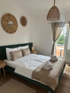 a bedroom with a large bed with towels on it at Villa Nada in Lovran