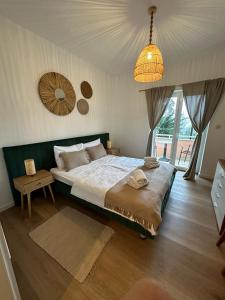 a bedroom with a large bed and a chandelier at Villa Nada in Lovran