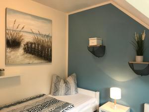 ein Schlafzimmer mit einem Bett und einem Wandgemälde in der Unterkunft Schwalbennest in Zingst