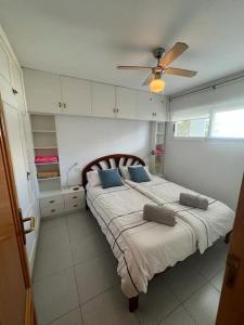 een slaapkamer met een bed en een plafondventilator bij Zee zicht apartement Altea 2 pers in Caserío Capnegret