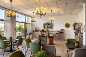 a restaurant with tables and chairs and a counter at Stephanos Hotel Apartments in Polis Chrysochous