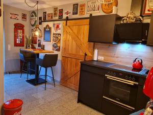 a kitchen with a black stove and a table at Premium Apartment in Sehnde +11 photos