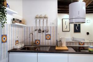 a kitchen with a sink and a counter top at Appartamento Ca’ del Baffo @riocadelbaffo in Riomaggiore +12 photos