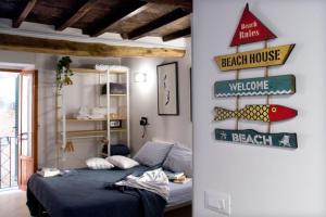 a bedroom with a bed and signs on the wall at Appartamento Ca’ del Baffo @riocadelbaffo in Riomaggiore