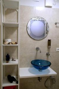 a bathroom with a blue sink and a mirror at Appartamento Ca’ del Baffo @riocadelbaffo in Riomaggiore
