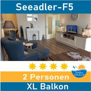 a living room with a couch and a tv at Seeadler-F5 in Heiligenhafen