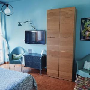 a bedroom with a dresser and a cabinet with a tv at Residenza dei Pini in Civitanova Marche
