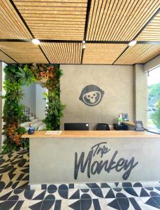 a lobby with a counter with a monkey sign on it at Trip Monkey del Río in San Gil