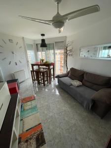 salon z kanapą i zegarem na ścianie w obiekcie Atlantico w mieście Calpe +20 zdjęć