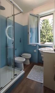 a bathroom with a toilet and a sink and a shower at Como Petite Maison in Como