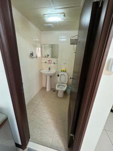 a bathroom with a toilet and a sink at 一中自在居 in Taichung