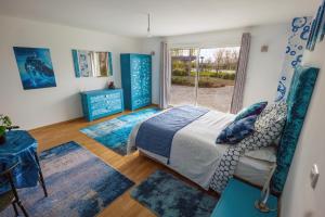 a bedroom with a bed and a large window at Chez PhiL - Le calme proche de Revel, Castelnaudary, Carcassonne in La Pomarède +42 photos