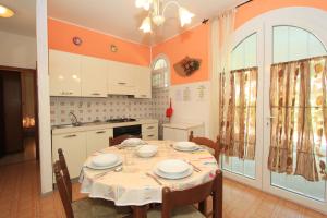 a kitchen with a table with plates on it at Appennini Villas in Lido di Pomposa