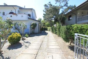 a path in front of a house with trees at Appennini Villas in Lido di Pomposa +8 photos