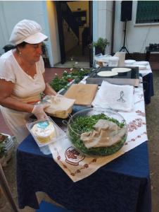 a woman standing at a table with food on it at C.R.D.D. Due Torri Riccione in Riccione