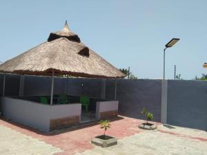 a large umbrella and some chairs and a table at AJALA Lodge in Badagry