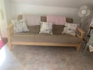 a couch with pillows on it in a living room at Chambres d' Hotes a Benaize in Coulonges