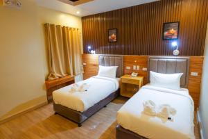 Postel nebo postele na pokoji v ubytování Raim Hotel