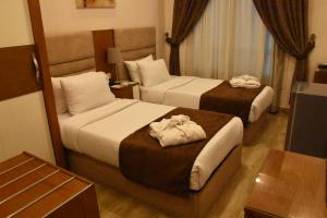 Ένα ή περισσότερα κρεβάτια σε δωμάτιο στο Zamalek Army Hotel