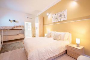 a bedroom with a bed and a bunk bed at Montellino's Suite Oro in SantʼAntìoco
